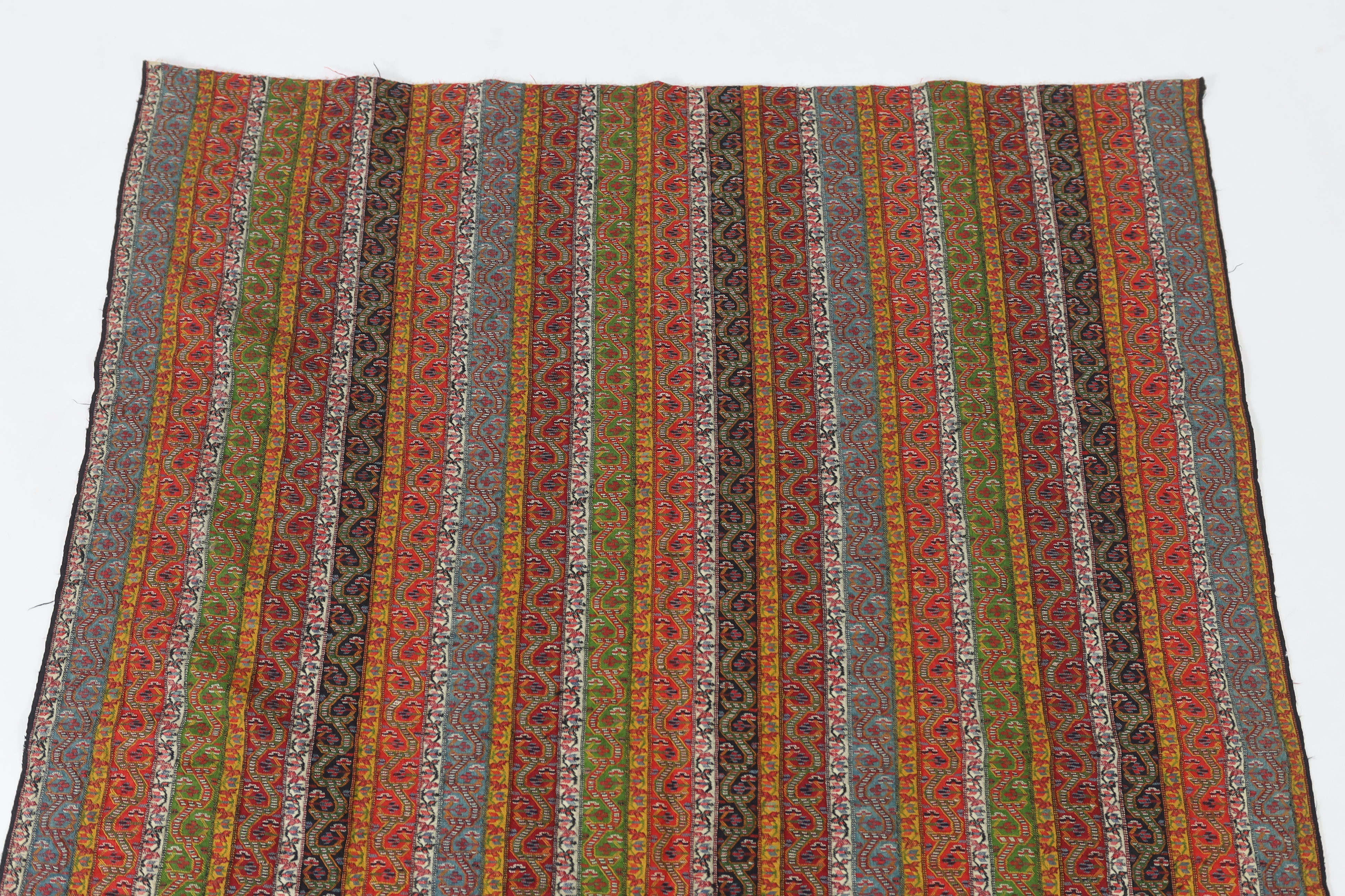 A 19th century Kashmir, multi coloured, striped twill, woven wool shawl, with the fringe cut one end, 140cm long x 114cm wide